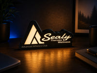 Sealy Therapy & Wellness illuminated custom light box on a desk